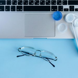 White and Blue Contact Lens Container on the Blue Table